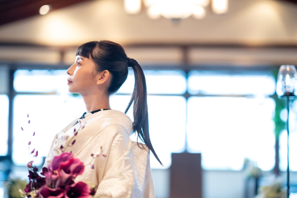 夜景に映える鮒鶴京都鴨川リゾートと和装の新郎新婦の後ろ姿(京都の和婚会場)